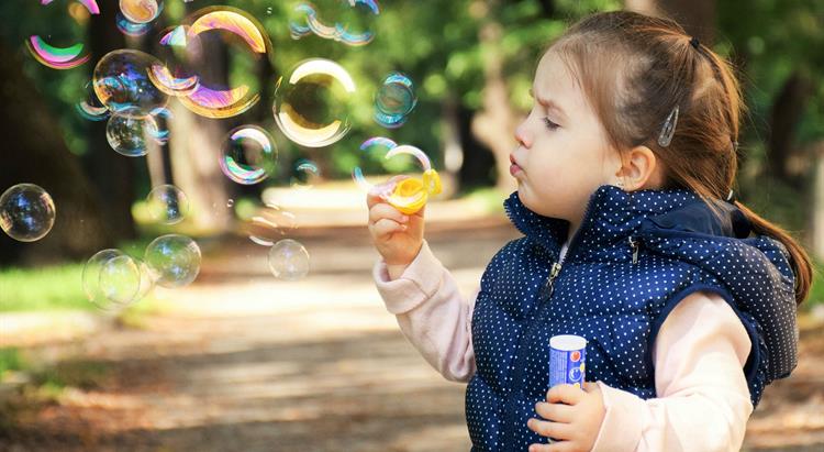 Child blowing a bubble 