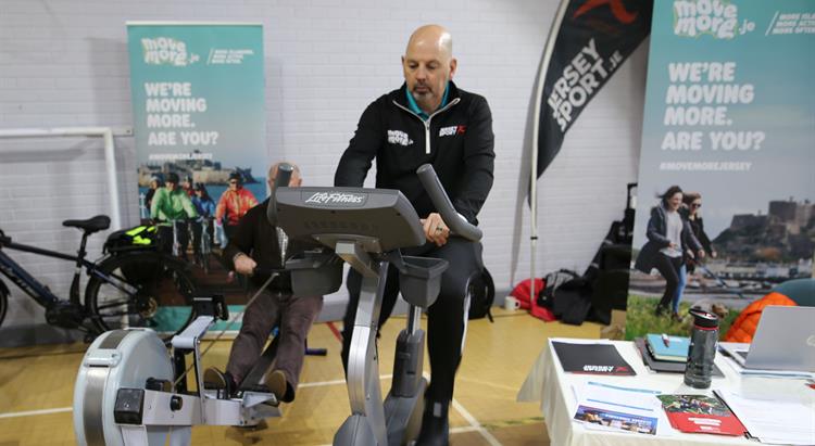 A man on an exercise bike at a closer to home event
