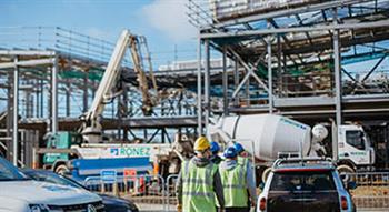 People walking towards a building site