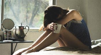 Woman sitting with cup of tea