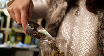 Woman pouring grains in a jar