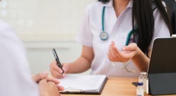 Nurse holding a pen and writing at a desk
