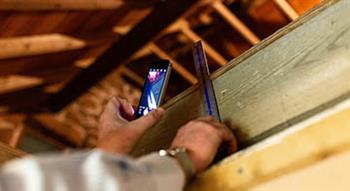 Man measuring inside a construction site