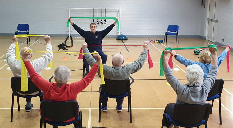 Photograph of Jonny Grimster leading a community physiotherapy group