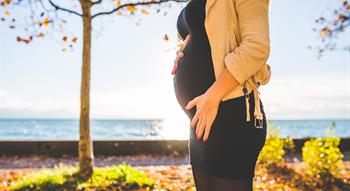 Woman holding baby bump