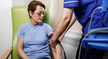 Nurse taking woman's blood pressure