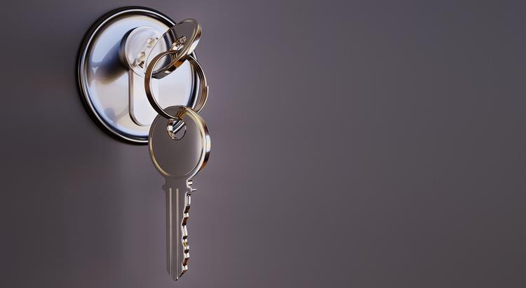 Image of a key in a front door lock
