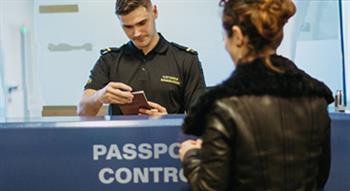 Photo of women having passport check by customs officer