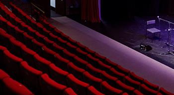 Photo of stage and red seating