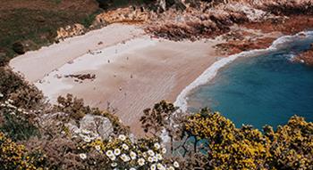 Photo of Beauport bay, summer time, low tide with sea crashing on sand