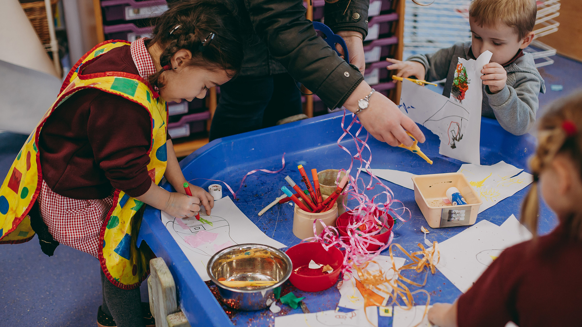 Photo of children colouring at table