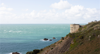 Image out to sea with a german bunker to the right of the photo