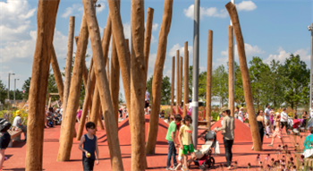 Families playing in a modern park with large structures