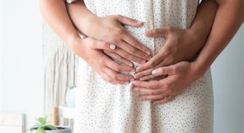 Couple holding baby bump