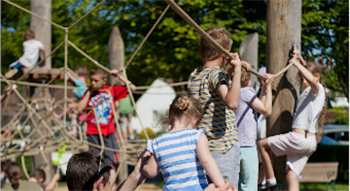 Children playing in a rope park between trees