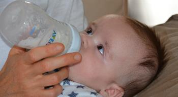 Baby being bottle fed