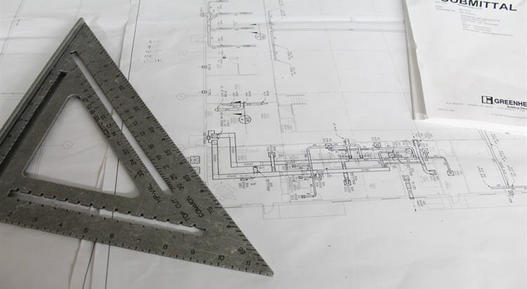 Ruler on top of a page of building plans