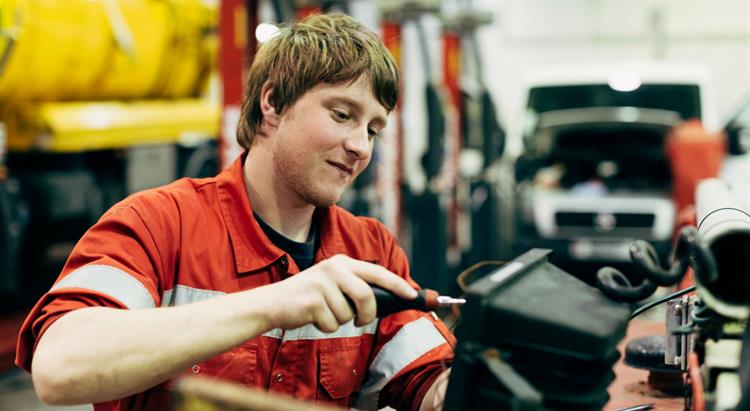 An engineer fixes a piece of machinery