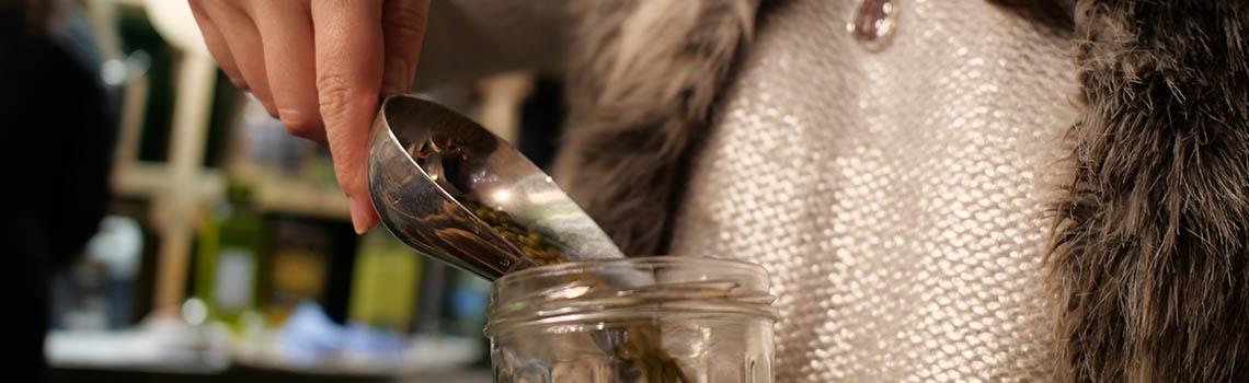 Woman pouring product in a jar