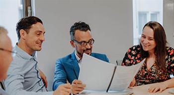 People in an office looking at a document