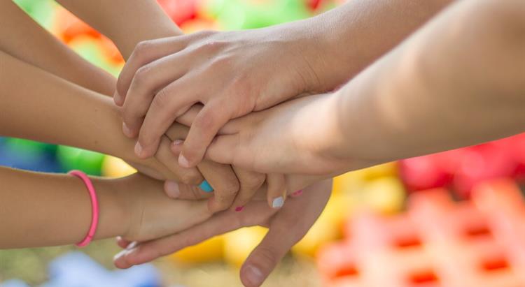 Children's hands on top of one another