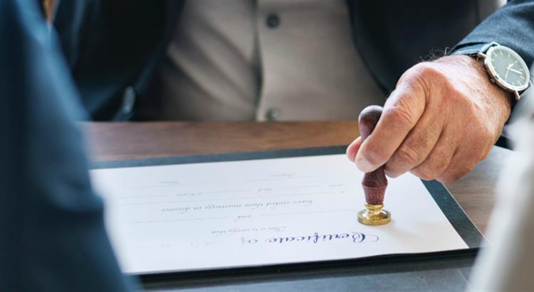 Photo of certificate of marriage being stamped