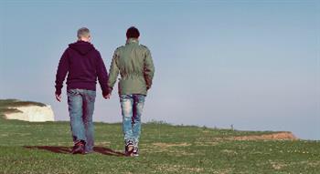 Photo of two men holding hands