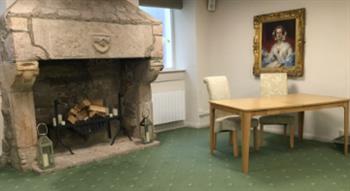Photo of fire place and table with chairs