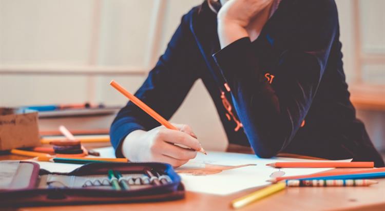 Student at a desk writing