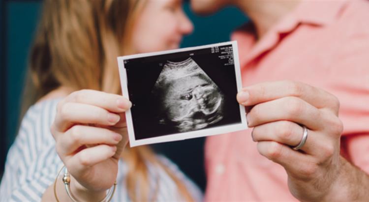 picture of a couple with a scan of a baby