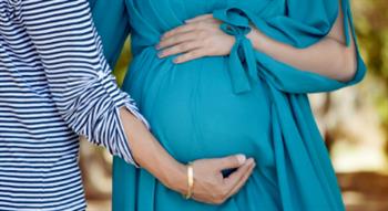 man holding womans baby bump